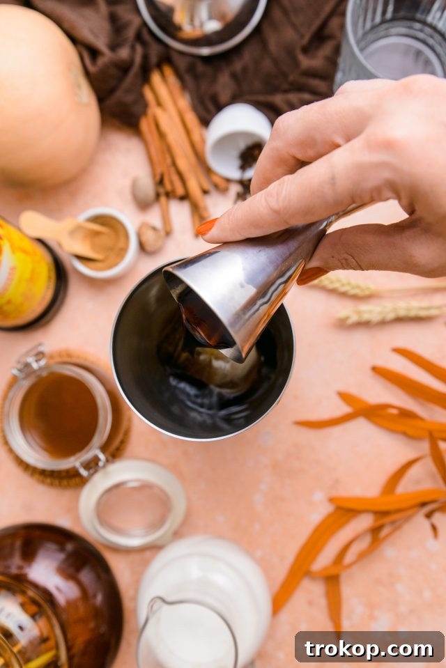 Instructions on how to make a Pumpkin Spice White Russian cocktail are illustrated.