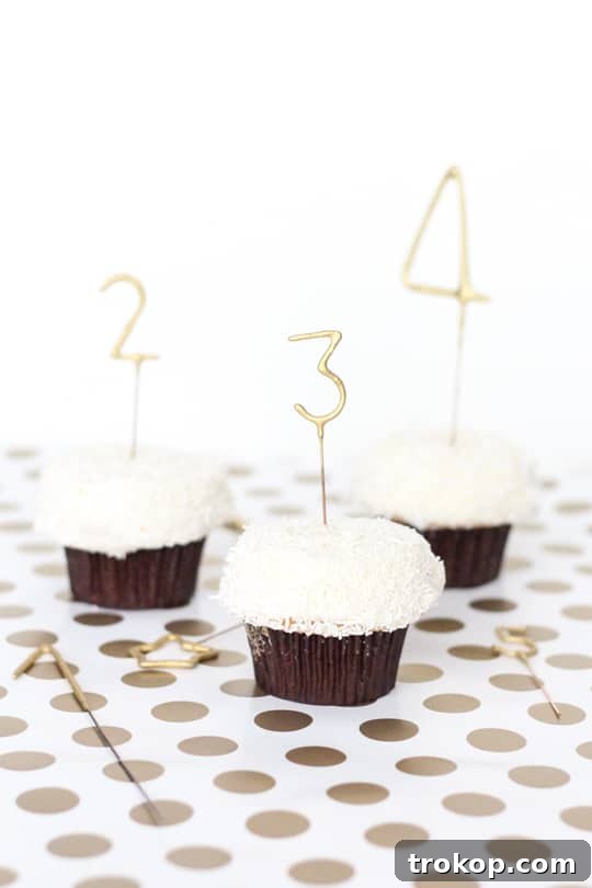 DIY Countdown Cupcakes - A group of cupcakes with gold number sparklers, ready for a New Year's Eve party.