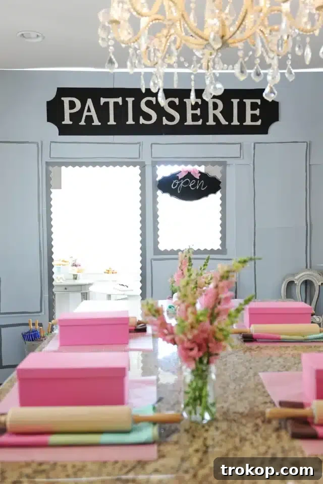 French Patisserie Storefront for Paris Theme Party Ideas, featuring a blue facade and fresh flowers.