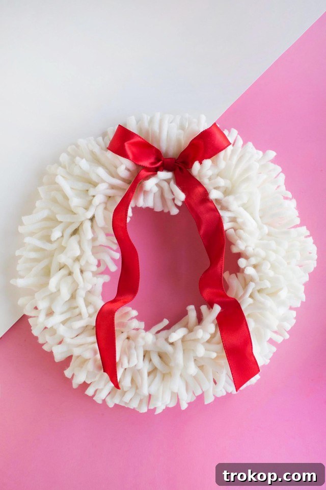 27 Handmade Christmas Wreaths for a Festive Home 11 Playful and colorful DIY Yarn Wreath