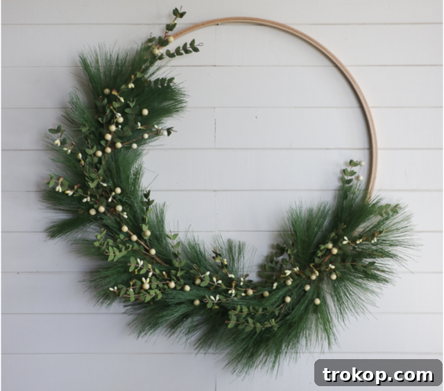 27 Handmade Christmas Wreaths for a Festive Home 12 Minimalist DIY Hoop Christmas Wreath with faux fir