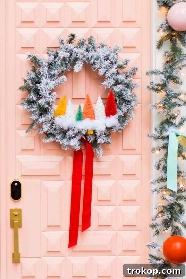 27 Handmade Christmas Wreaths for a Festive Home 3 Colorful rainbow sisal tree Christmas wreath on a pink front door