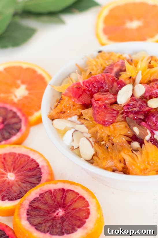 Assembling a Citrus Yogurt Bowl, drizzling honey over oranges