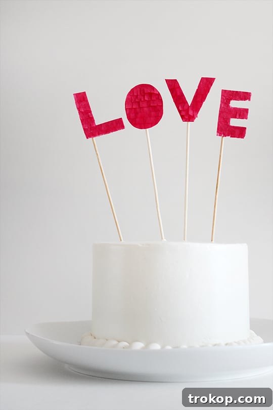 Handmade Fringed Love Cake Topper 9 Fringed 'LOVE' cake topper standing out on a cake, ready for celebration