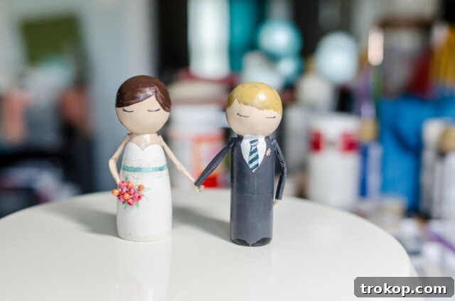 17 DIY Cake Toppers to Make Your Celebration Unforgettable 12 DIY Hand Holding Peg People Cake Topper