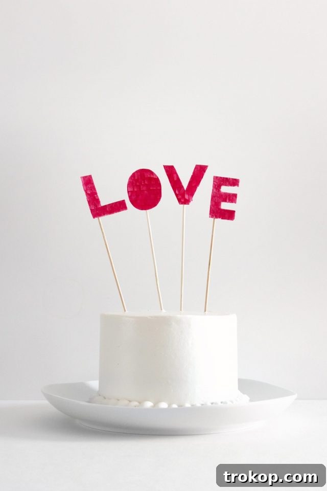 17 DIY Cake Toppers to Make Your Celebration Unforgettable 6 DIY Fringed love cake topper - Sugar and Cloth