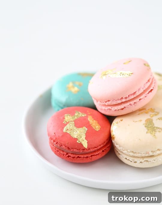 Beautifully finished DIY edible gold macarons arranged on a plate