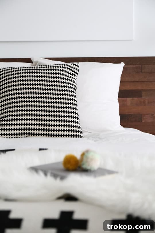 Close-up of the finished Stikwood DIY headboard on an IKEA bed