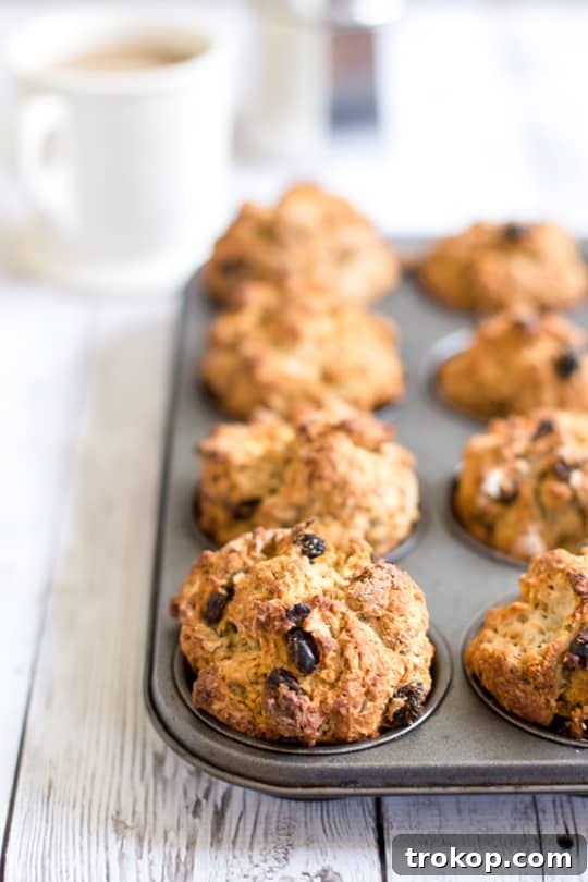A close-up of a tray of freshly baked Irish Soda Bread Knots, piping hot and golden from the oven.