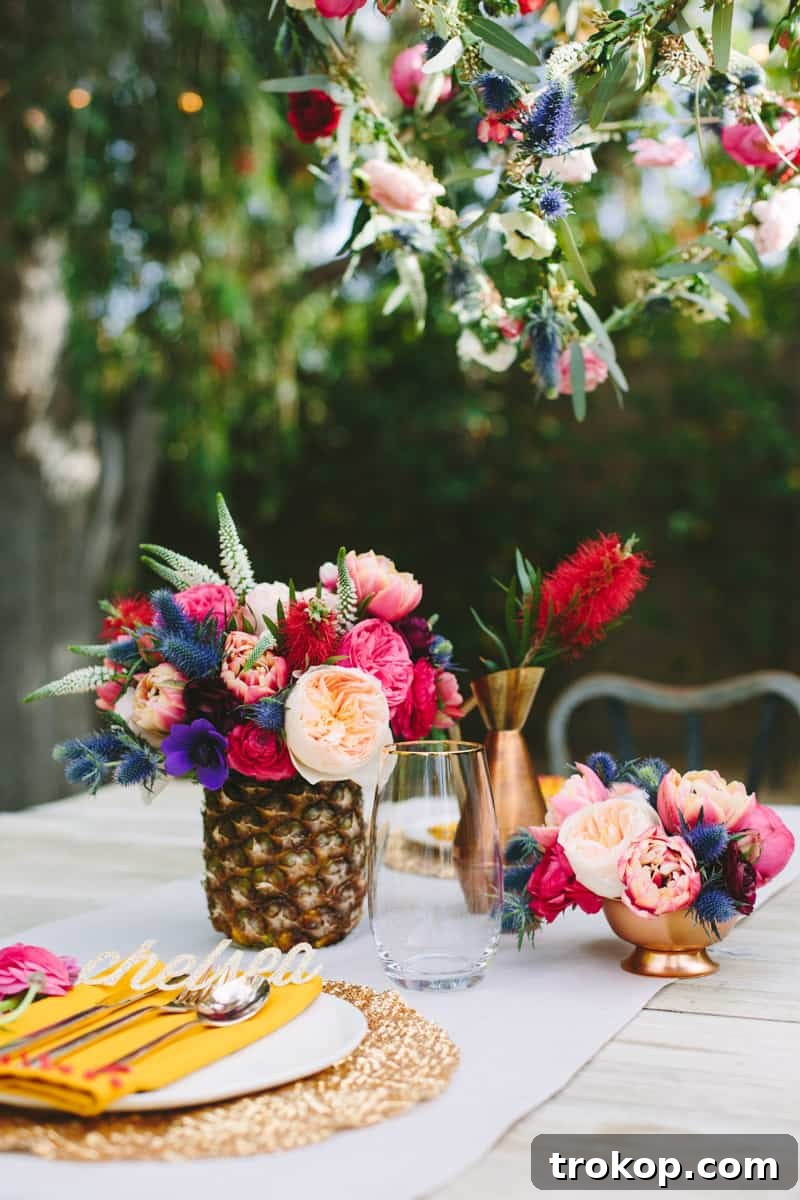 Elegant floral tablescape in Palm Springs featuring a golden pineapple vase